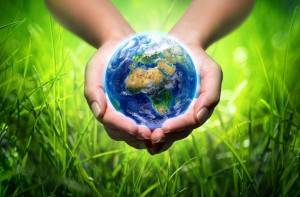 earth in hands - grass background - environment concept - Europe